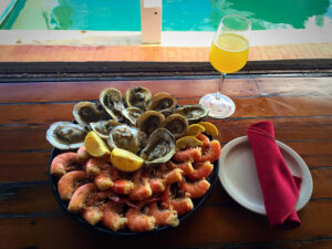 oyster and seafood on plate with drink and napkin