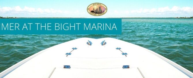 the front part of a boat extending out into the cool blue ocean water with a key west historic seaport logo on top.